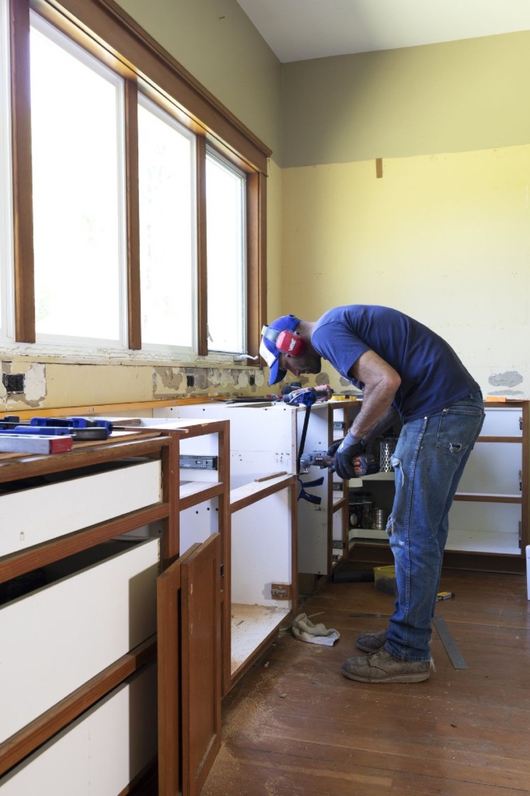 Contractor installing kitchen cabinets